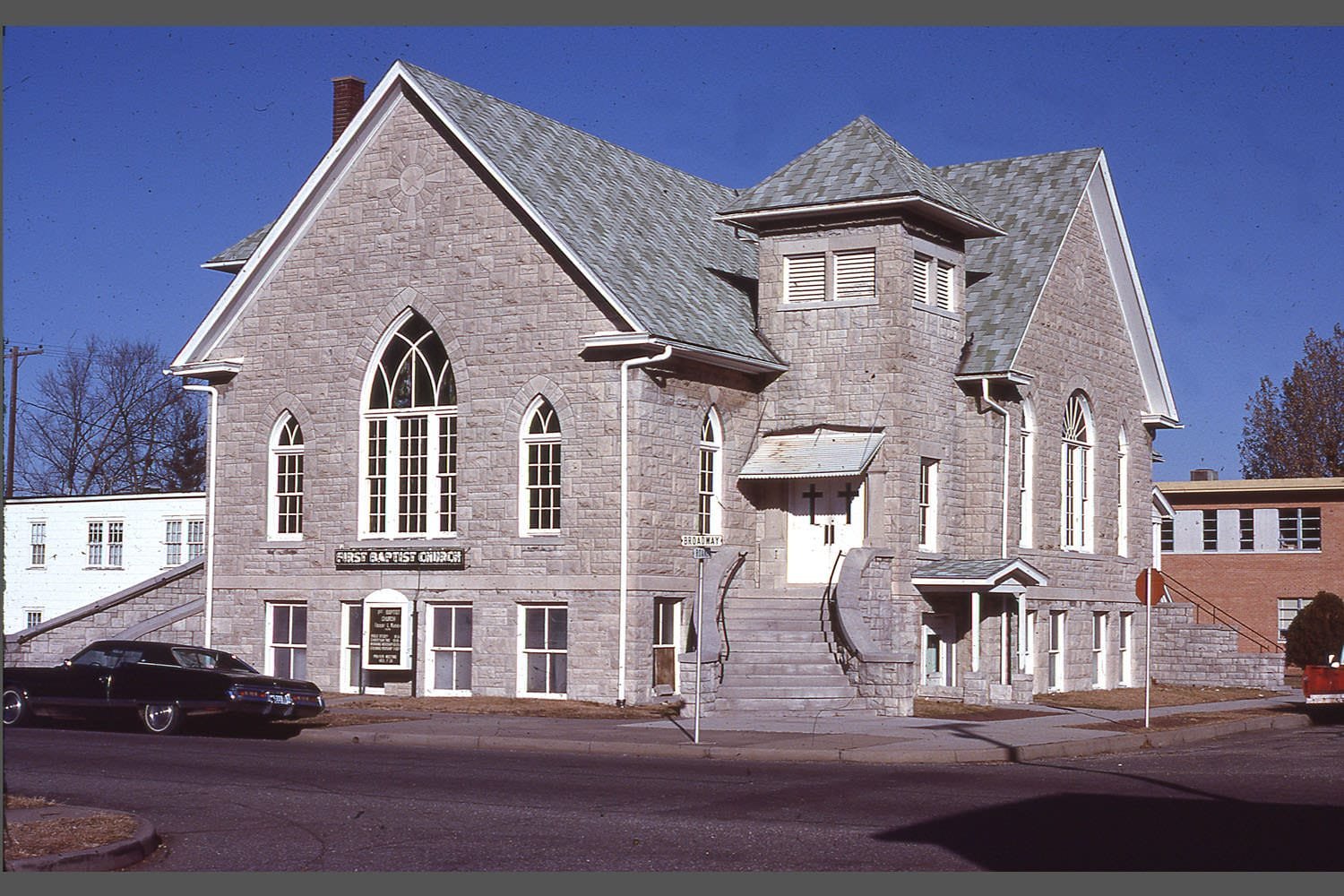 The First Baptist Church building was located at the northwest corner of Broadway and Roane Streets. It was constructed during the pastorate of the Rev. Fred B. Kinell, which was from 1910 to 1922. The exterior was made of Carthage stone. The building served the congregation until 1981, when it was replaced by the current red brick building.