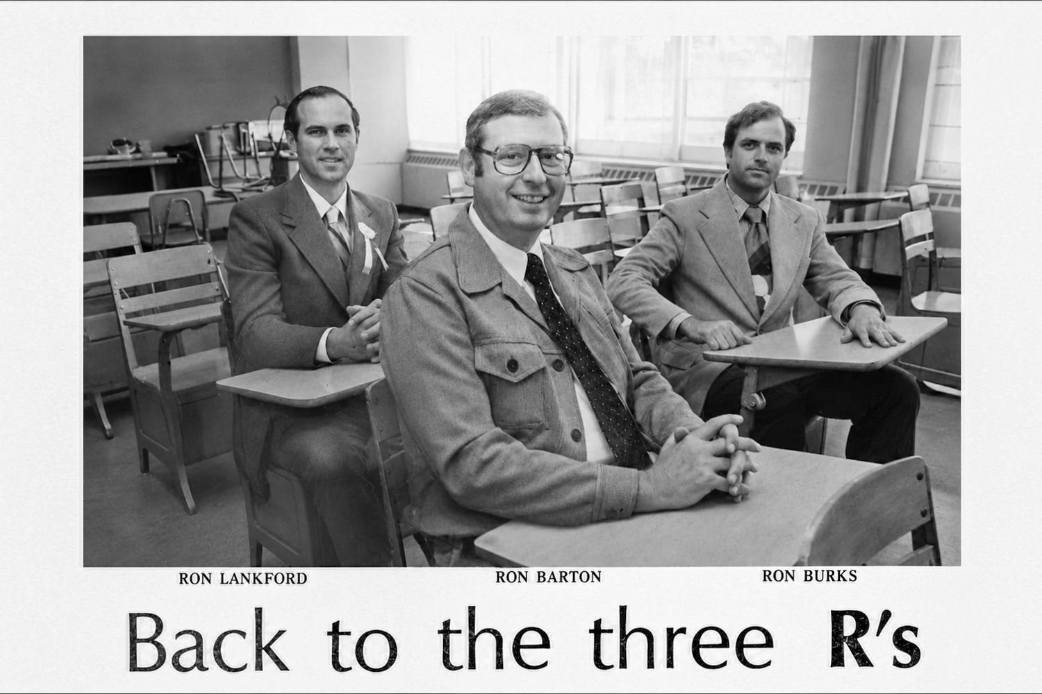 Three men in a classroom sit at old desks, smiling for the camera, with a 'Back to the three R's' caption below.
