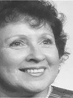 Close-up grayscale portrait of a smiling woman with short dark hair.