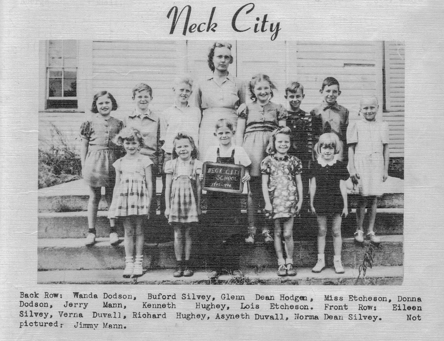 Vintage black-and-white group photo of elementary students on steps, with a teacher, Neck City School sign visible (caption lists names).